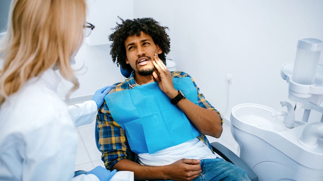 Man with Toothache in Dental Chair